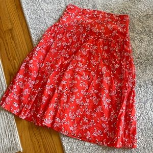 Knee length skirt, poppy red with white/black flowers.